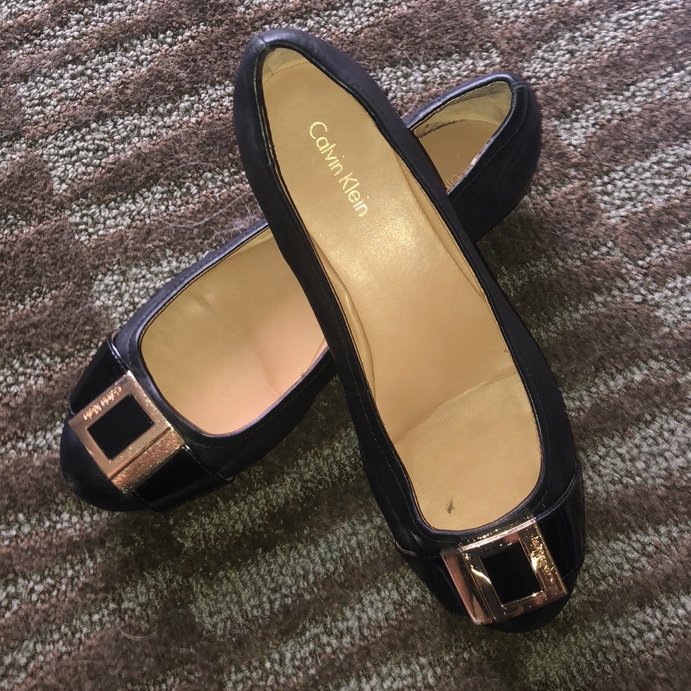 Calvin Klein black slip on flats with gold buckle